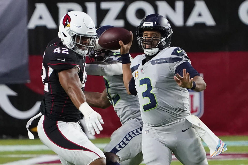 Seattle Seahawks quarterback Russell Wilson (3) throws as Arizona Cardinals outside linebacker Devon Kennard (42) defends during the first half of an NFL football game, Sunday, Oct. 25, 2020, in Glendale, Ariz. (AP Photo/Rick Scuteri)