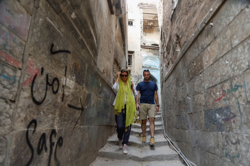 Anna Nikolaevna, 38, a Russian national, and Jacob Nemec, 29, an American national during a tour of the old city of Mosul