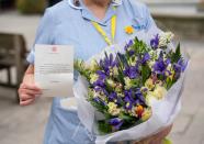 Flowers and a message from the Queen to staff at St Bartholomew’s Hospital (Dominic Lipinski/PA)