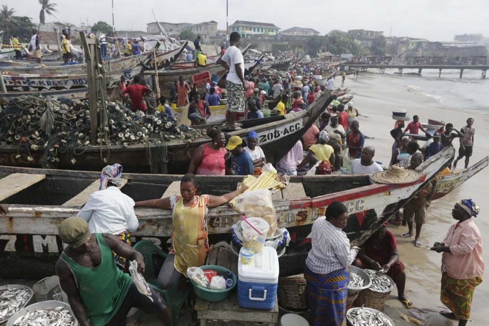 FILE - Fishermen sort their early morning catch from nets, at the fishing beach in the James Town area of Accra, Ghana, July 9, 2015. Corruption is undermining the management of some of the world’s most threatened fishing grounds, according to a review of criminal case files and media reports by the AP. At least 45 government officials have been accused of graft or extortion in the past two decades. (AP Photo/Sunday Alamba, File)