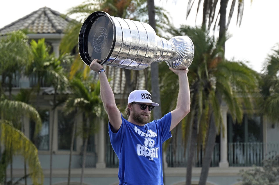 Tampa Bay Lightning center Steven Stamkos hoists the Stanley Cup during the NHL hockey Stanley Cup champions' Boat Parade, Monday, July 12, 2021, in Tampa, Fla. (AP Photo/Phelan M. Ebenhack)