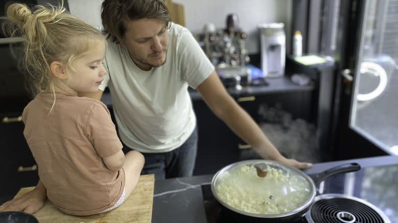 man and child making popcorn