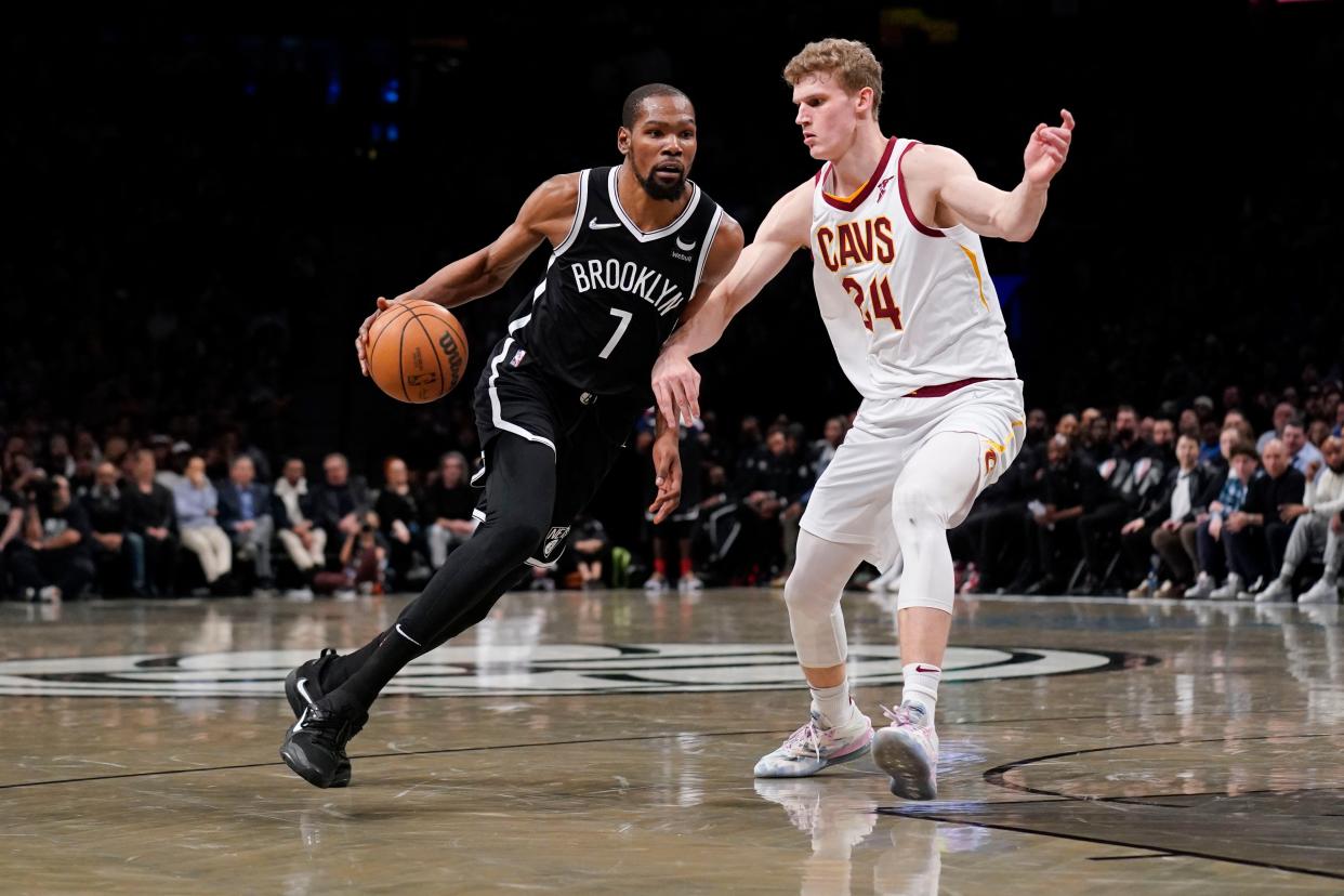 Brooklyn Nets' Kevin Durant, left, drives past Cleveland Cavaliers' Lauri Markkanen during the opening basketball game of the NBA play-in tournament Tuesday in New York. The Nets defeated the Cavaliers 115-108 and claimed the No. 7 seed in the NBA playoffs. SETH WENIG/AP