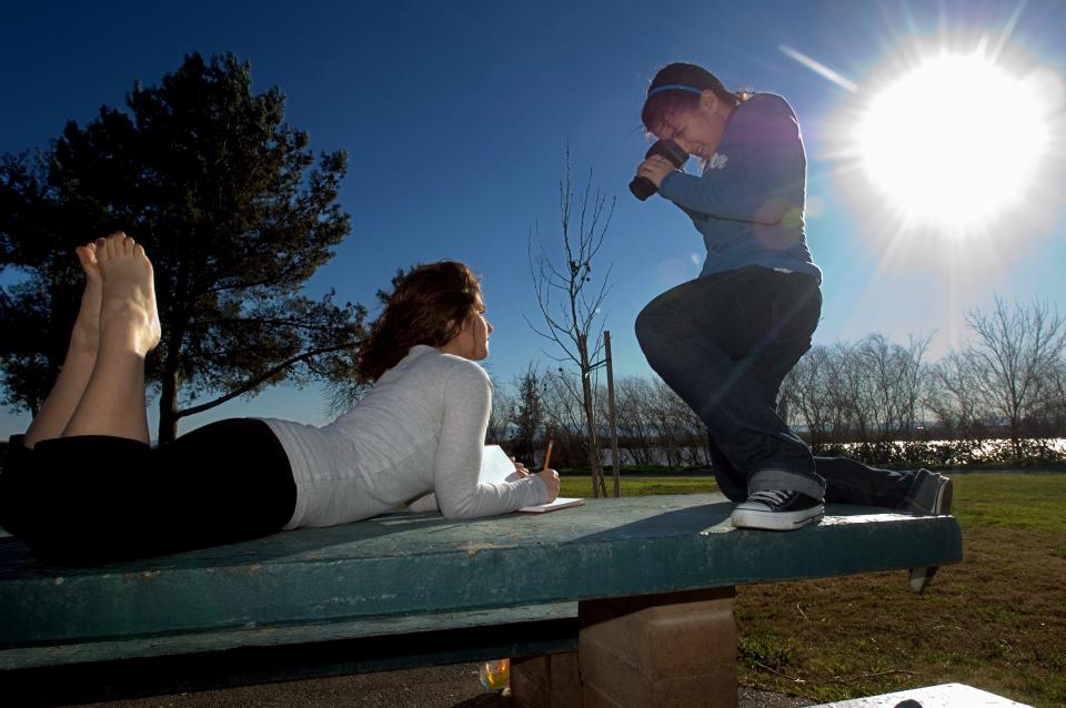 SIxteen-year-old Lincoln High student Lulu Skafi, right, takes advantage of the sunny day to take a picture of her sister Shereen Skafi, 21, for a photo class project at Buckley Cove Park in Stockton on Feb, 4, 2008.