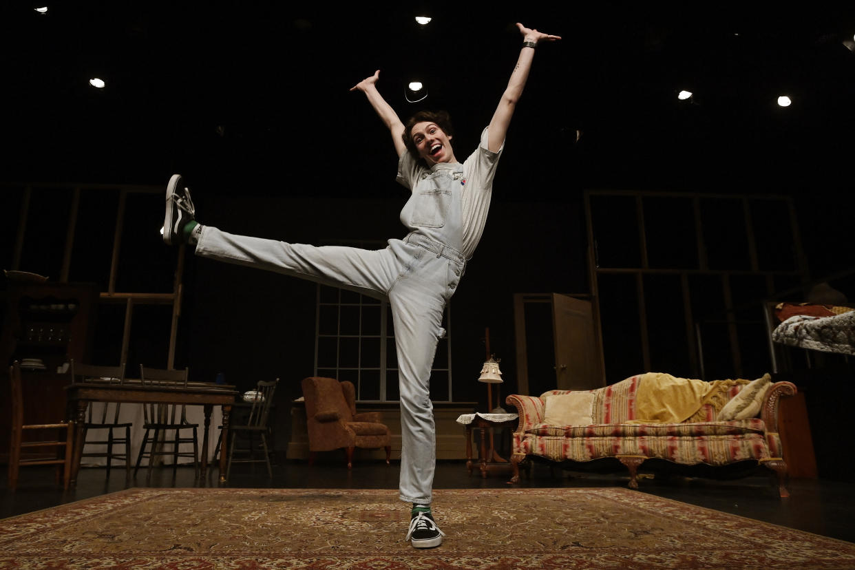 Grayson Hart jumps for a portrait at the Ned R. McWherter West Tennessee Cultural Arts Center in Jackson, Tenn., on Saturday, March 4, 2023, where he directs a youth theater program. Hart was accepted into every college he applied to, but turned them down. He is one of thousands of young adults who graduated high school during the pandemic and are taking career routes other than college. (AP Photo/Mark Zaleski)