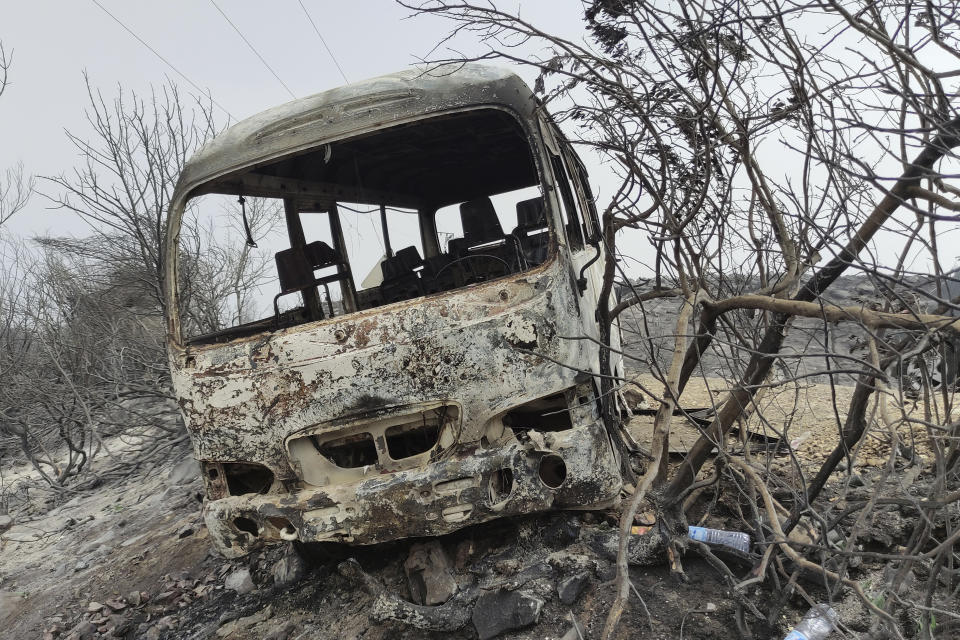 A charred van is photographed in the region of El Tarf, near the northern Algerian-Tunisian border, Thursday, Aug.18, 2022. Wildfires raging in the forests of eastern Algeria have killed at least 26 people, according to a "provisional report" by the north African country's interior minister. (AP Photo/Mohamed Ali)