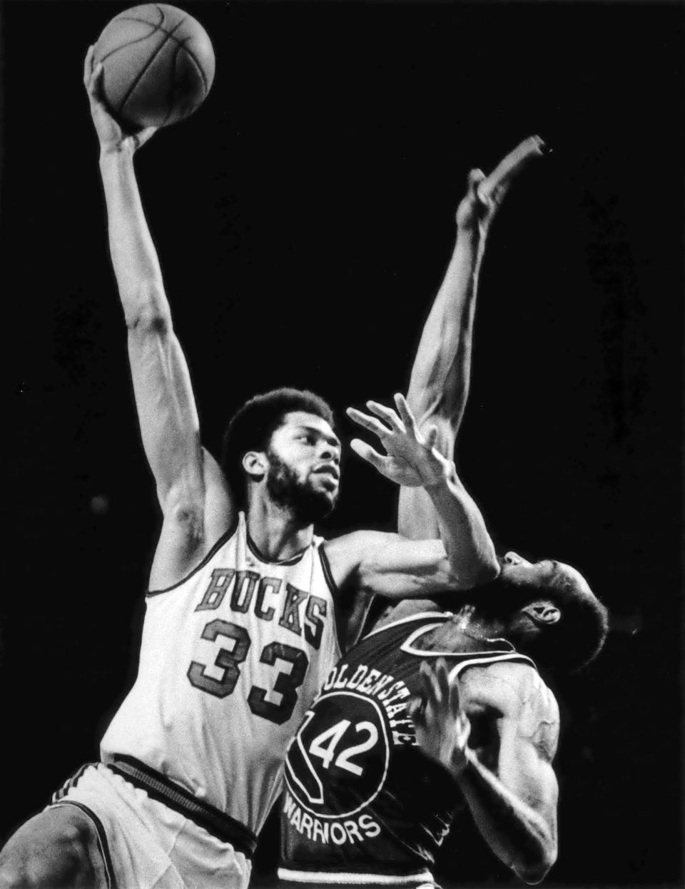 Milwaukee Bucks center Kareen Abdul-Jabbar shots against the Golden State Warrior's Nate Thurmond during a game in March, 1974.