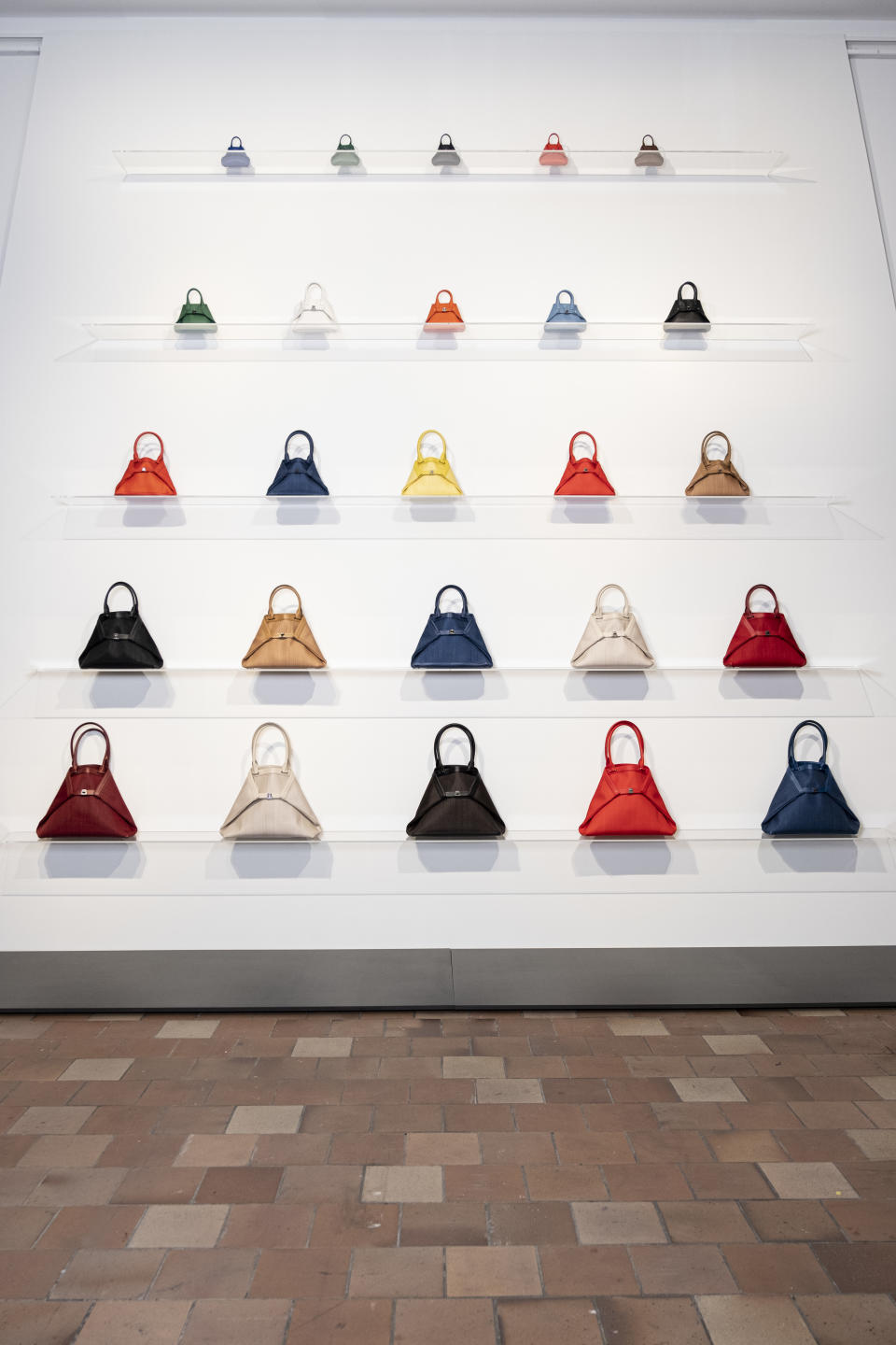 Akris Ai bags made of horsehair are arranged in a trapezoid formation.