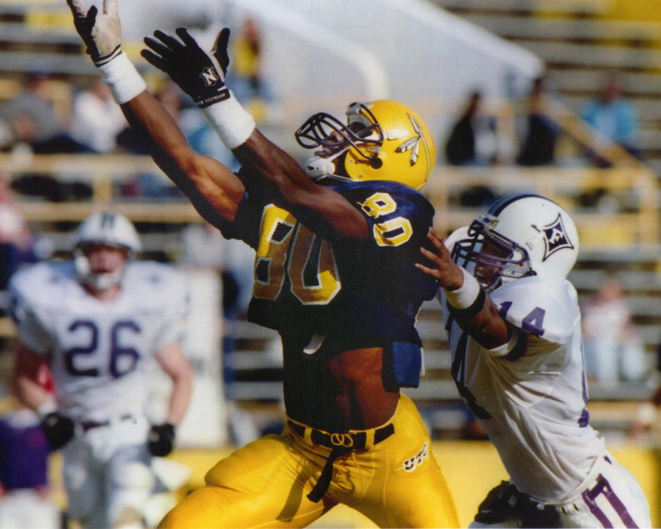 In this undated photo provided by the University of Tennessee Chattanooga athletic department, wide receiver Terrell Owens (80) plays in an NCAA college football game for the school. Owens will be giving his Hall of Fame induction speech at the University of Tennessee at Chattanooga on Saturday, Aug. 4, 2018, where he played college football, rather than appearing at the ceremony in Canton with his fellow honorees. (UTC Athletics via AP)