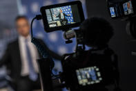 Peter Szijjarto, Hungary's minister of foreign affairs and trade, is displayed in a video camera monitors as he speaks during an interview with the Associated Press at United Nations headquarters, Thursday, Sept. 23, 2021, during the 76th Session of the U.N. General Assembly in New York. (AP Photo/John Minchillo)