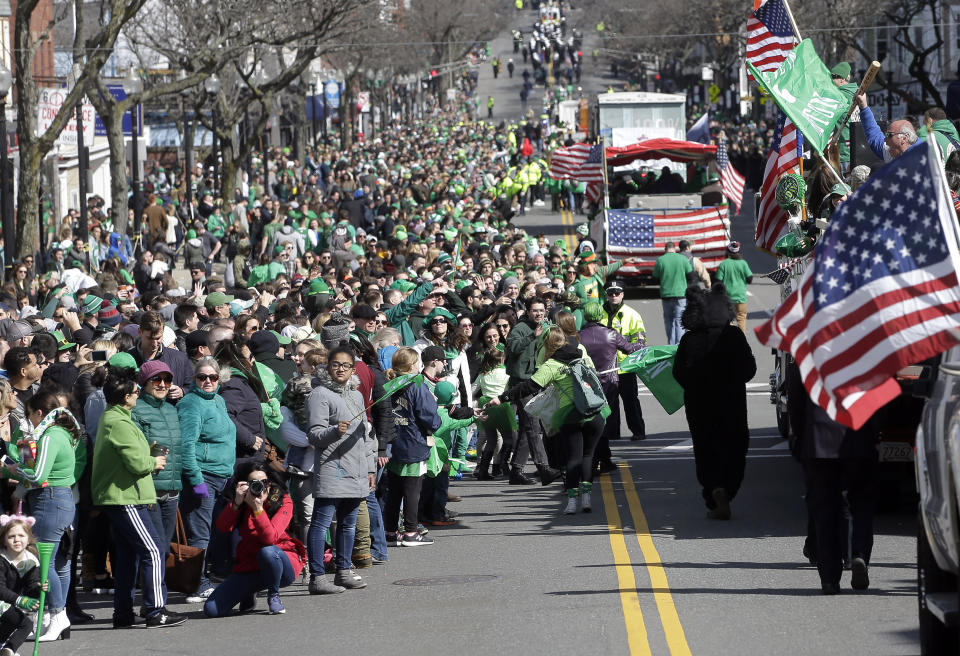 Spectators partially fill a street during a portion of the annual St. Patrick's Day parade, Sunday, March 17, 2019, in Boston's South Boston neighborhood. The city celebrated the holiday with crowds lining the route of the 118th edition of the parade. (AP Photo/Steven Senne)