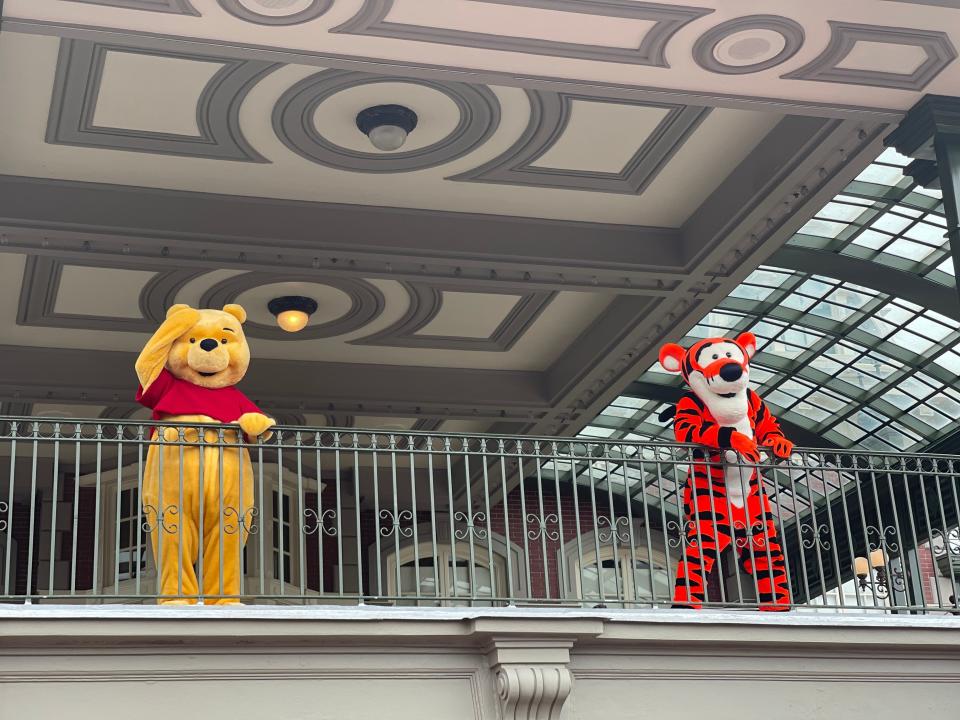 winnie the pooh and tigger on the train platform at magic kingdom in disney world