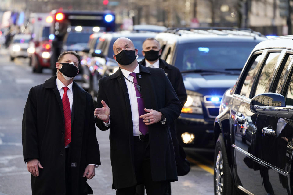 Security look upward as Vice President Kamala Harris, and her husband Doug Emhoff, ride during the Inauguration Day Parade Route in Washington, Wednesday, Jan. 20, 2021, after being sworn in as the 46th vice president of the United States. (AP Photo/Jacquelyn Martin)