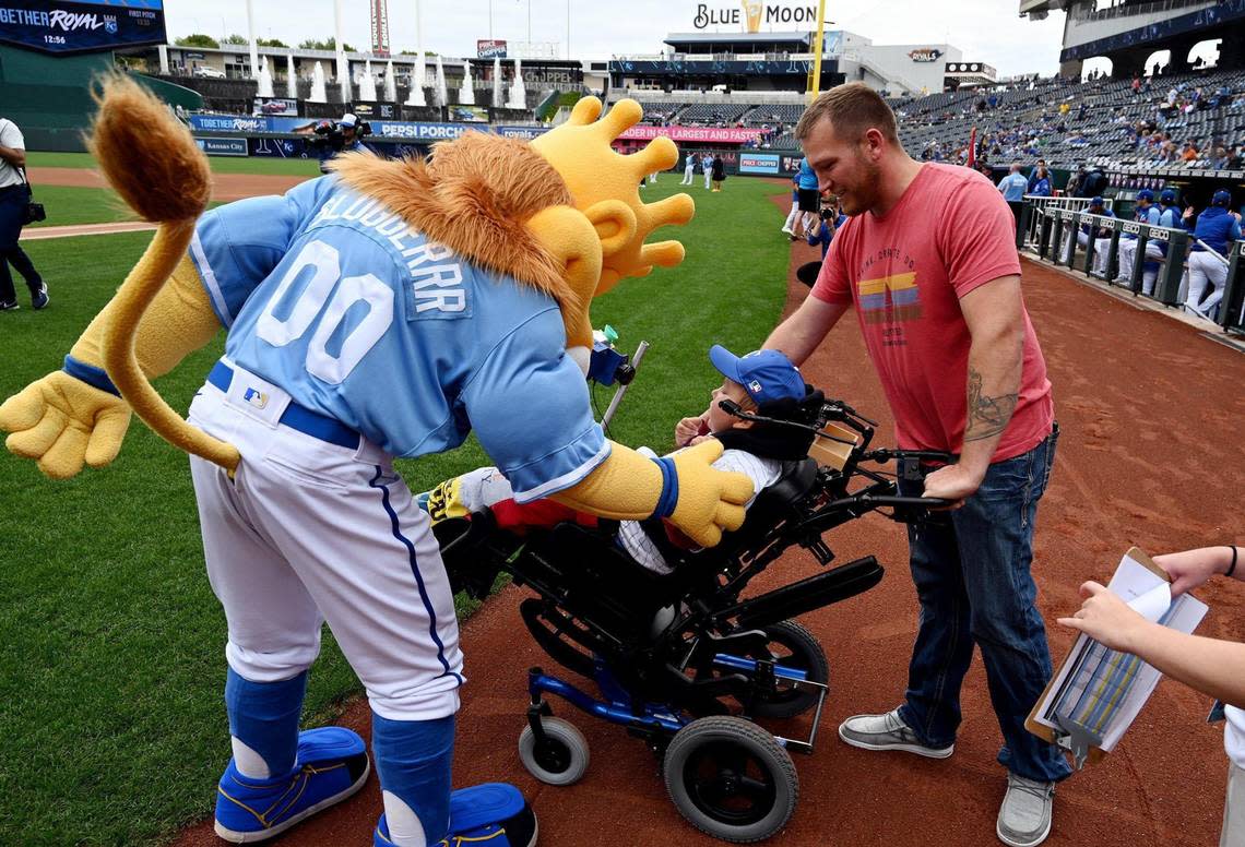 Kayden Rhoades was given 24 hours to live at birth, but 15 years later he threw out the first pitch on Thursday at Kauffman Stadium with the loving help of his family. Rhoades, who was born with hydranencephaly, used a device his father Dustin created for him to complete the feat. He even got to meet Sluggerrr, who caught the first pitch from Kayden. It was a bucket list day in every way for the family from Sioux City, Iowa.