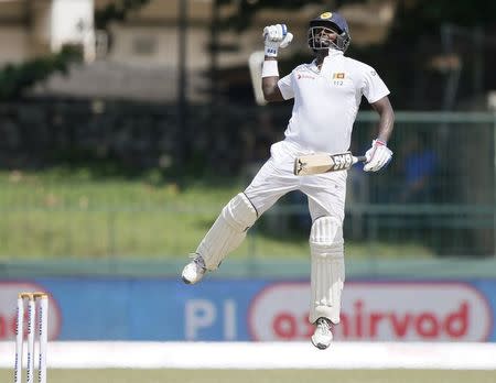 Sri Lanka's captain Angelo Mathews celebrates his century during the final day of their third and final test cricket match against India in Colombo, September 1, 2015. REUTERS/Dinuka Liyanawatte