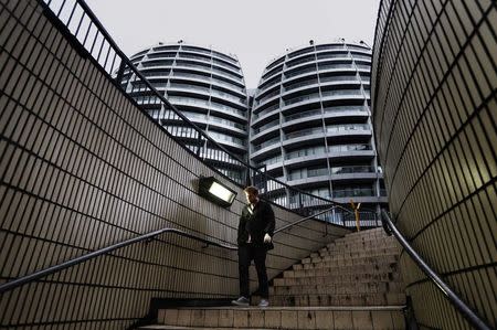 A man walks down a flight of stairs near buildings surrounding the Old Street roundabout, dubbed "Silicon Roundabout", in London, in this May 28, 2013 file photo. REUTERS/Luke Macgregor/Files