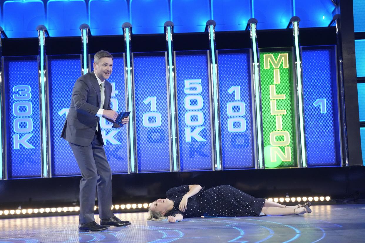 Christiana Trapani, co-owner of Door County Candle Co., falls to the ground next to host Chris Hardwick after the green ball falls into the $1 million slot, adding that amount to her winnings on the NBC-TV game show "The Wall." Christiana was a contestant with her husband, Nic, on the April 11 season premiere of the show, where the couple won more than $1.3 million.