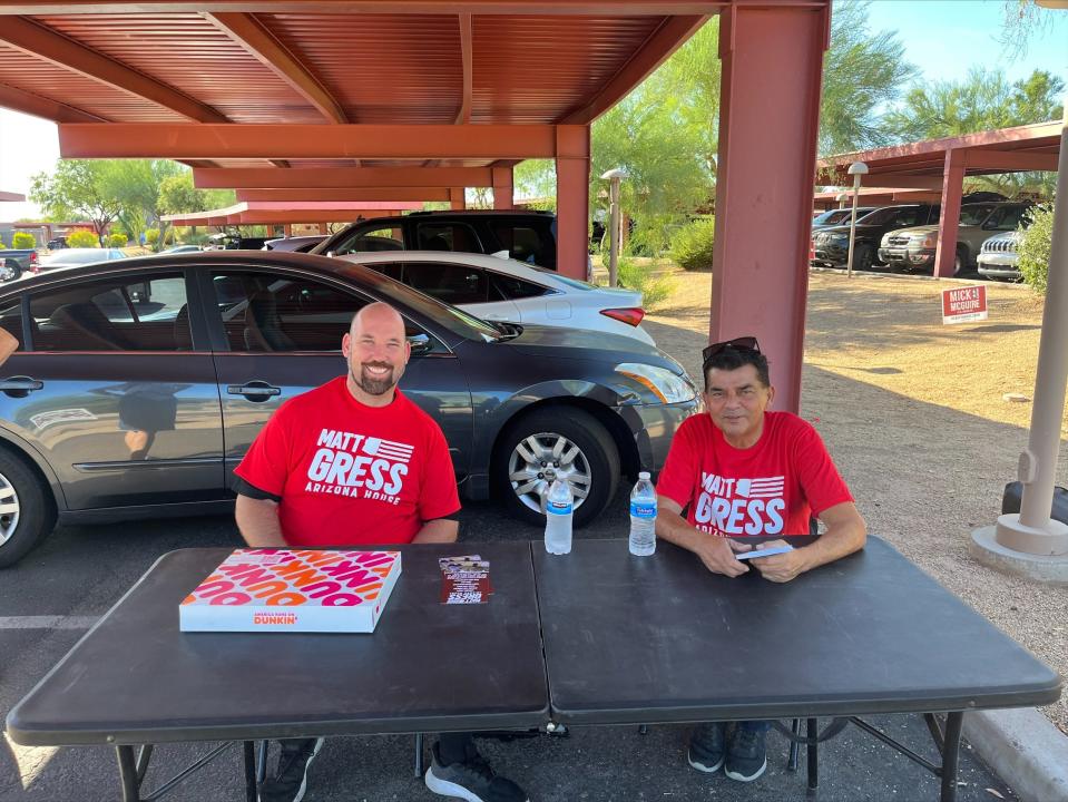 Derek Toohey (left), from Phoenix, and Michael Haney, from Peoria, campaign for Republican Arizona house candidate Matt Gress outside of the Paradise Valley Town Hall polling place after they were told by polling staff to take down their tent.