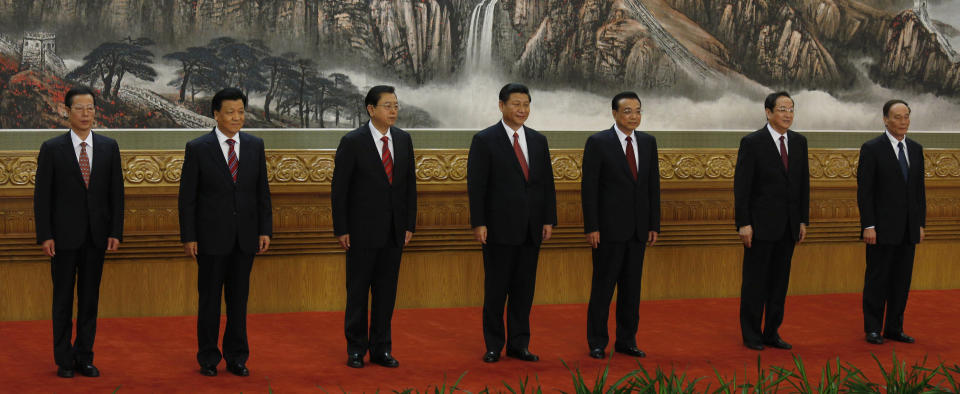 New members of the Politburo Standing Committee, from left, Zhang Gaoli, Liu Yunshan, Zhang Dejiang, Xi Jinping, Li Keqiang, Yu Zhengsheng and Wang Qishan stand together at Beijing's Great Hall of the People Thursday Nov. 15, 2012. The seven-member Standing Committee, the inner circle of Chinese political power, was paraded in front of assembled media on the first day following the end of the 18th Communist Party Congress. (AP Photo/Vincent Yu)