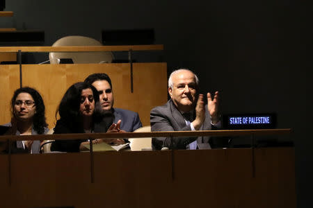 Palestinian Ambassador to the United Nations Riyad Mansour applauds following the adoption of a draft resolution by the United Nations General Assembly to deplore the use of excessive force by Israeli troops against Palestinian civilians at U.N. headquarters in New York, U.S., June 13, 2018. REUTERS/Mike Segar