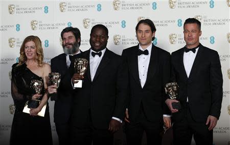 Director Steve McQueen (C) celebrates with Dede Gardner (L-R), Anthony Katagas, Jeremy Kleiner and Brad Pitt after winning Best Film for "12 Years a Slave" at the British Academy of Film and Arts (BAFTA) awards ceremony at the Royal Opera House in London February 16, 2014. REUTERS/Suzanne Plunkett