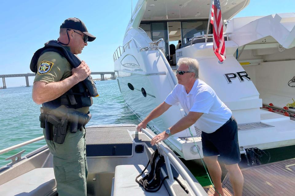 Barry Hurt, captain of the Destin-based charter boat "Propensity," talks with Okalooa County Sheriff's Deputy Andrew Maltais after flagging Maltais' marine patrol vessel over to ask a question about a specific boating regulation. Okaloosa County Sheriff's Office deputies are gearing up for the upcoming tourist season and the large influx of boaters it brings.