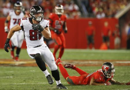 Nov 3, 2016; Tampa, FL, USA; Atlanta Falcons tight end Austin Hooper (81) runs past the diving Tampa Bay Buccaneers cornerback Brent Grimes (24) during the second half of a football game at Raymond James Stadium. The Falcons won 43-28. Mandatory Credit: Reinhold Matay-USA TODAY Sports