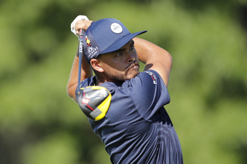 Rickie Fowler hits from the 18th tee during the first round of the Rocket Mortgage Classic golf tournament, Thursday, July 2, 2020, at the Detroit Golf Club in Detroit. (AP Photo/Carlos Osorio)