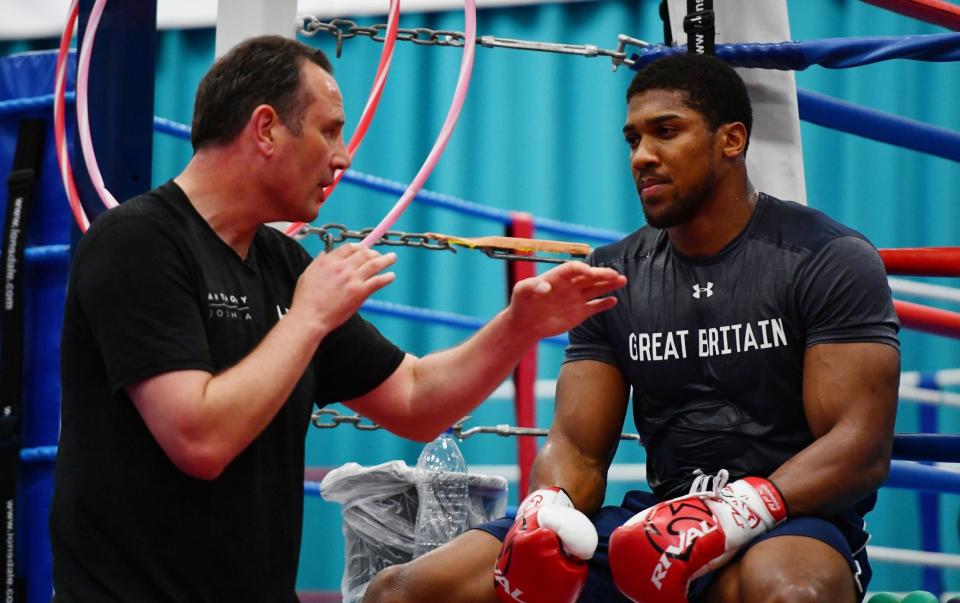 Anthony Joshua speaks with coach Rob McCracken during the media workout at EIS Sheffield on April 19, 2017 in Sheffield, England. - GETTY IMAGES