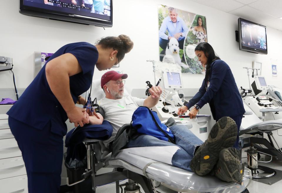 From left, Donor Technicians Yovanka De Lemos and Jacqueline Rodriguez prepare Todd Wilson for his blood donation at New York Blood Center in Elmsford Oct. 5, 2023.