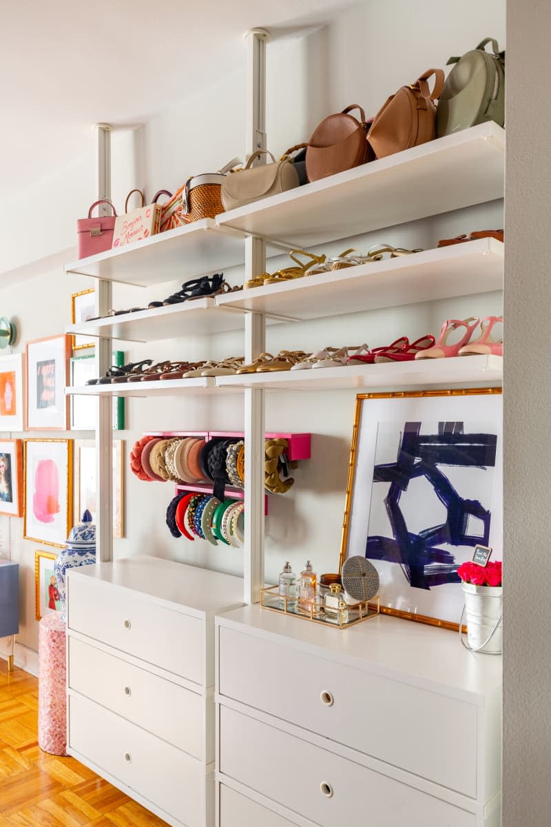 Storage for an assortment of shoes, purses, and other accessories is displayed on a white shelving.