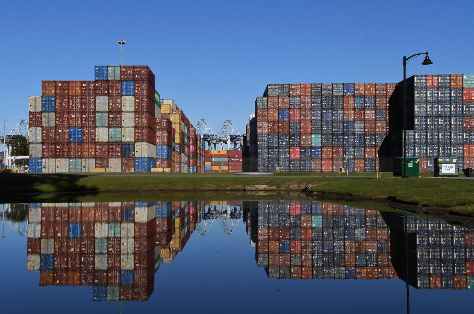 10/23/21: Shipping containers are seen reflected in a pond at the Port of Savannah in Georgia. The supply chain crisis has created a backlog of nearly 80,000 shipping containers at this port, the third-largest container port in the United States. (Photo by Paul Hennessy/SOPA Images/LightRocket via Getty Images)