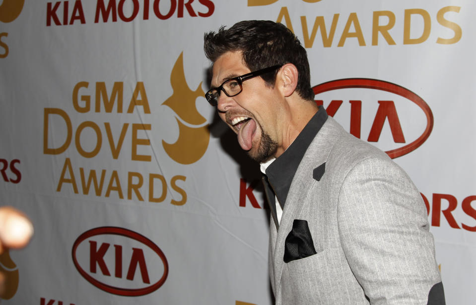 Gospel recording artist Jason Crabb jokes with photographers as he walks the red carpet before the Gospel Music Association Dove Awards at Atlanta's Fox Theater Thursday, April 19, 2012. Crabb is nominated for eight awards including artist of the year. (AP Photo/John Bazemore)