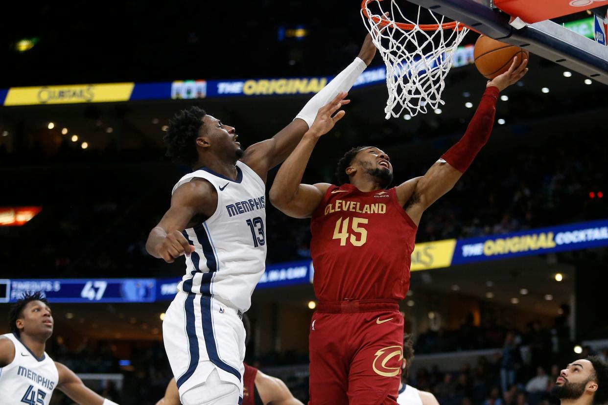 Feb 1, 2024; Memphis, Tennessee, USA; Cleveland Cavaliers guard Donovan Mitchell (45) drives to the basket as Memphis Grizzlies forward-center Jaren Jackson Jr. (13) defends during the first half at FedExForum. Mandatory Credit: Petre Thomas-USA TODAY Sports