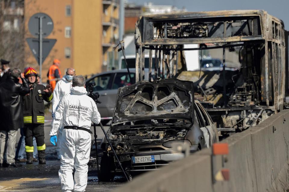 Forensic police and firefighters work by the wreckage of the school bus (AFP/Getty Images)