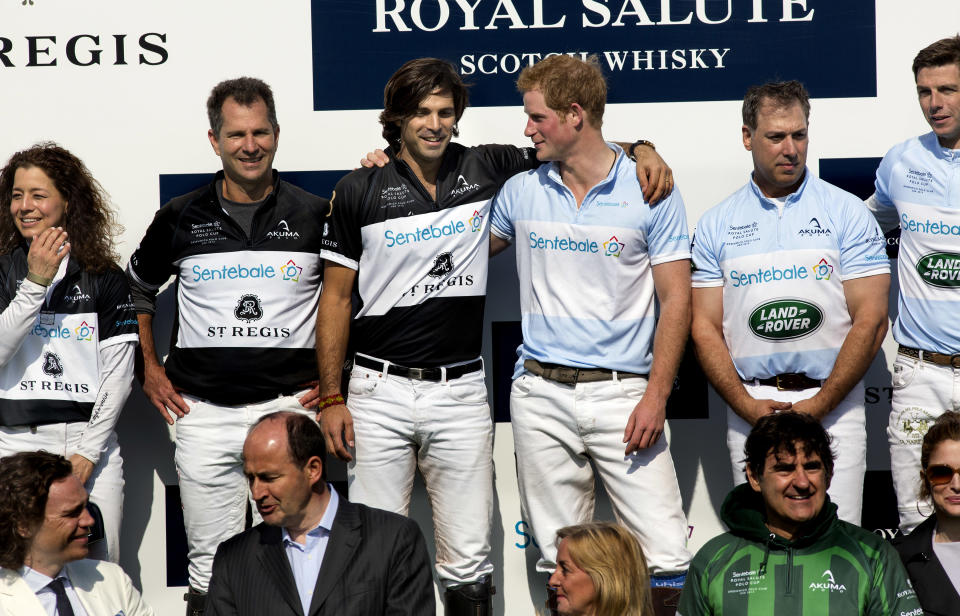 Britain's Prince Harry, center right, embraces opponent and polo player Nacho Figueras of Argentina after the Sentebale Royal Salute Polo Cup charity match in Greenwich, Conn., Wednesday, May 15, 2013. Prince Harry's team won the match. (AP Photo/Craig Ruttle)