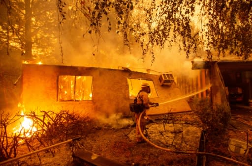 Firefighters battle flames at a burning apartment complex in Paradise, north of Sacramento, California on November 9, 2018