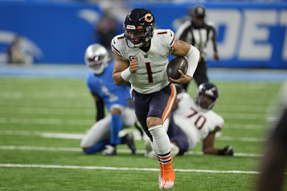 Chicago Bears quarterback Justin Fields scrambles during the first half of an NFL football game against the Detroit Lions, Sunday, Jan. 1, 2023, in Detroit. (AP Photo/Paul Sancya)