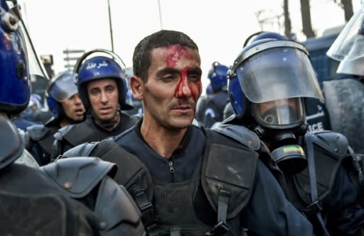 A member of the security forces in Algiers, where clashes broke out Friday between protesters and riot police