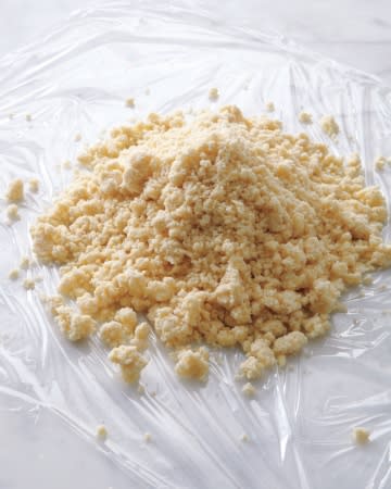 <div class="caption-credit"> Photo by: Martha Stewart Living</div><div class="caption-title">The Processed Dough Should Resemble Uneven Crumbs</div><b>The Processed Dough Should Resemble Uneven Crumbs</b> <br> When you empty the mixture from the food processor out onto the plastic wrap, some pieces will be tiny, others will be in clumps. This is exactly what you want. You're on your way to a light, flaky crust.