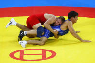 Mikhail Siamionau (red) of Belarus grapples with Darkhan Bayakhmetov (blue) of Kazakhstan in the Men's Greco-Roman 66kg Bronze bout at the China Agriculture University Gymnasium during Day 5 of the Beijing 2008 Olympic Games on August 13, 2008 in Beijing, China. (Clive Rose/Getty Images)