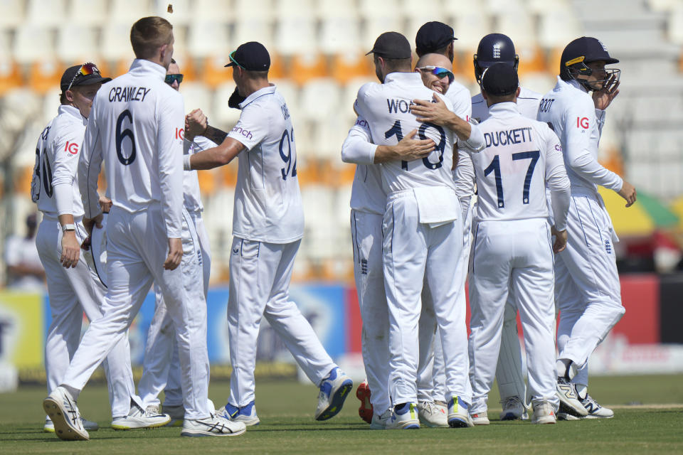 England's Jack Leach, center in glasses, and teammates are congratulated each others after winning the first test cricket match against Pakistan, in Multan, Pakistan, Friday, Oct. 11, 2024. (AP Photo/Anjum Naveed)