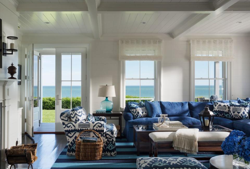 <p>Water views enhance the colors of this family room from <a href="https://deringhall.com/interior-designers/slc-interiors" rel="nofollow noopener" target="_blank" data-ylk="slk:SLC Interiors;elm:context_link;itc:0;sec:content-canvas" class="link ">SLC Interiors</a>.</p>