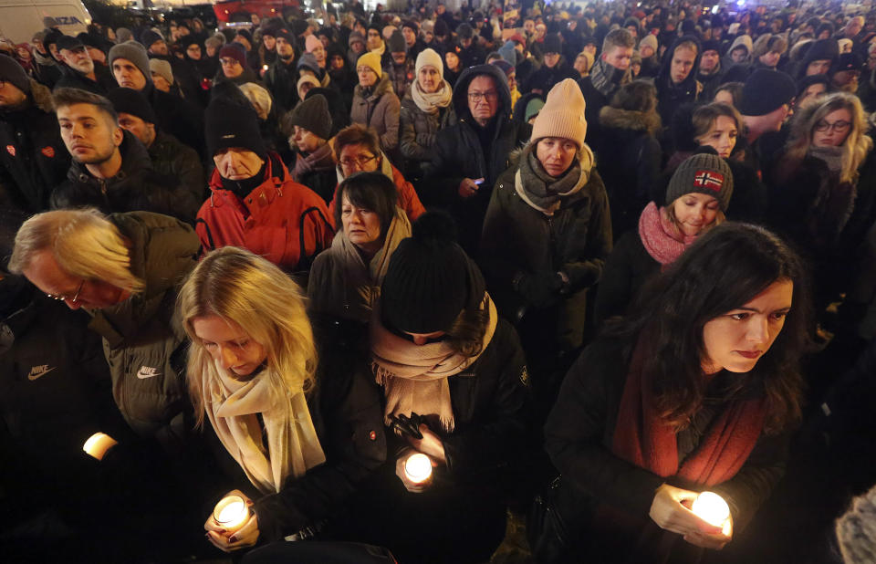 People hold lit candles in a memorial march for Gdansk Mayor Pawel Adamowicz, in Warsaw, Poland, Monday, Jan. 14, 2019. People in Poland are gathering for solemn vigils to honor Gdansk Mayor, 53-year-old Pawel Adamowicz. who died Monday after being stabbed at a fundraising event the night before. There were vigils in Warsaw and other cities across a nation shocked by the assassination. (AP Photo/Czarek Sokolowski)