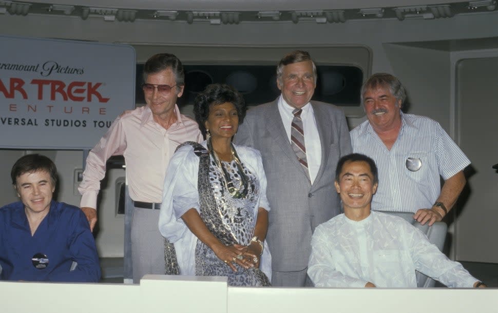 Gene Roddenberry stands alongside original 'Star Trek' cast members. 