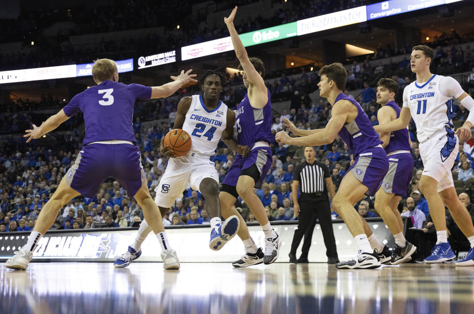 Creighton's Arthur Kaluma, second from left, drives for the basket against St. Thomas' Andrew Rohde, from left, Will Engels and Parker Bjorklund during the first half of an NCAA college basketball game on Monday, Nov. 7, 2022, in Omaha, Neb. (AP Photo/Rebecca S. Gratz)