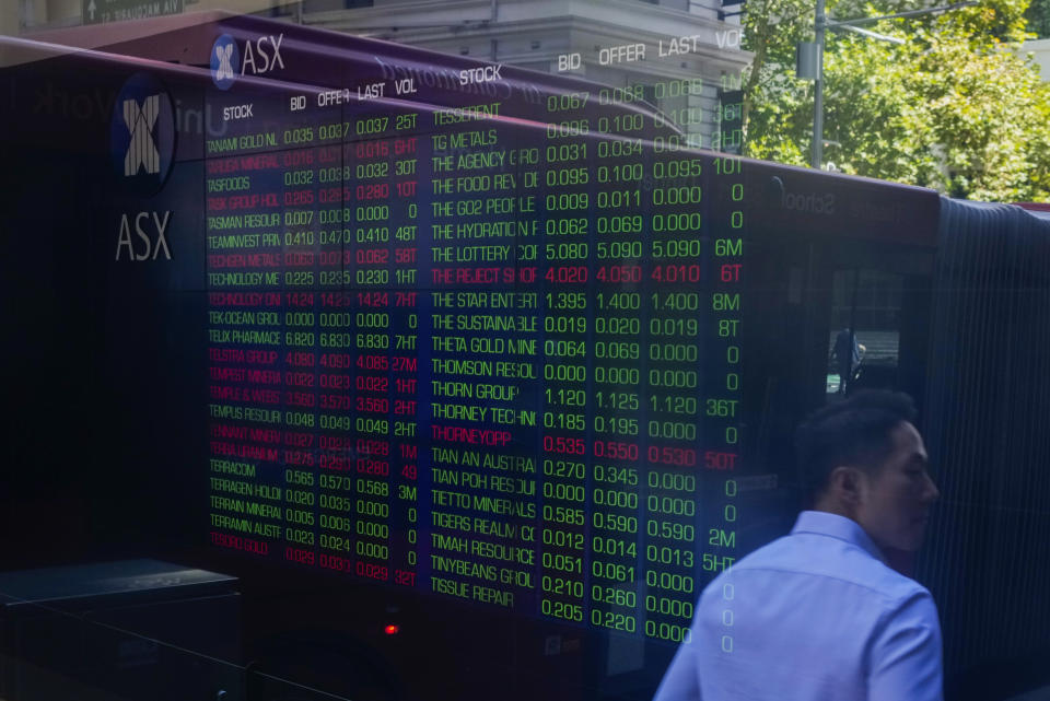 People are reflected in the window of the Australian Stock Exchange in central Sydney, Australia, Thursday, March 16, 2023. The Asian stock markets tumbled Thursday after Wall Street sank as a plunge in Credit Suisse shares reignited worries about a possible bank crisis following the failure of two U.S. lenders. (AP Photo/Mark Baker)