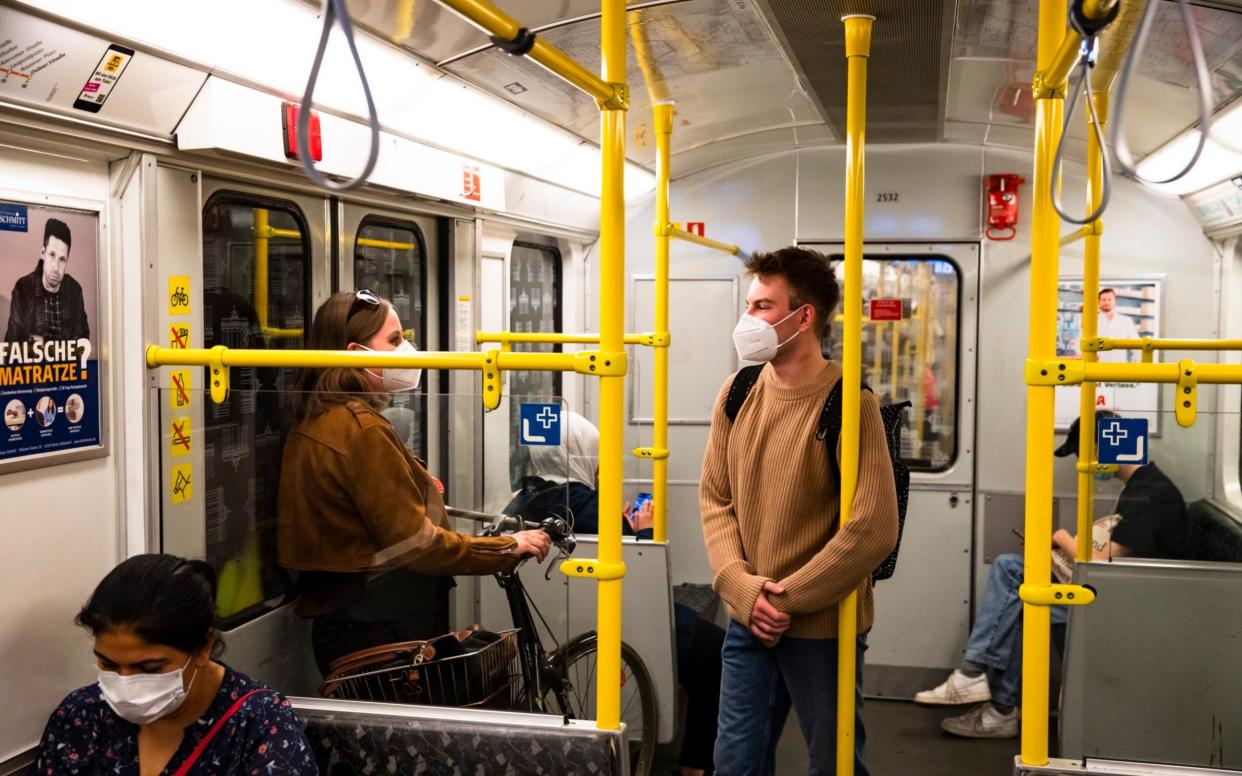 Face masks are mandatory on public transport in Berlin, as this picture shows - but footage (now taken down) of illegal 'corona parties' showed something altogether different - NurPhoto