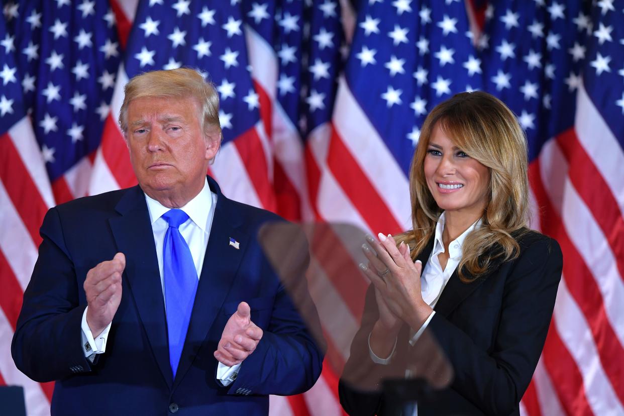 TOPSHOT - US President Donald Trump claps alongside US First Lady Melania Trump after speaking during election night in the East Room of the White House in Washington, DC, early on November 4, 2020. (Photo by MANDEL NGAN / AFP) (Photo by MANDEL NGAN/AFP via Getty Images)