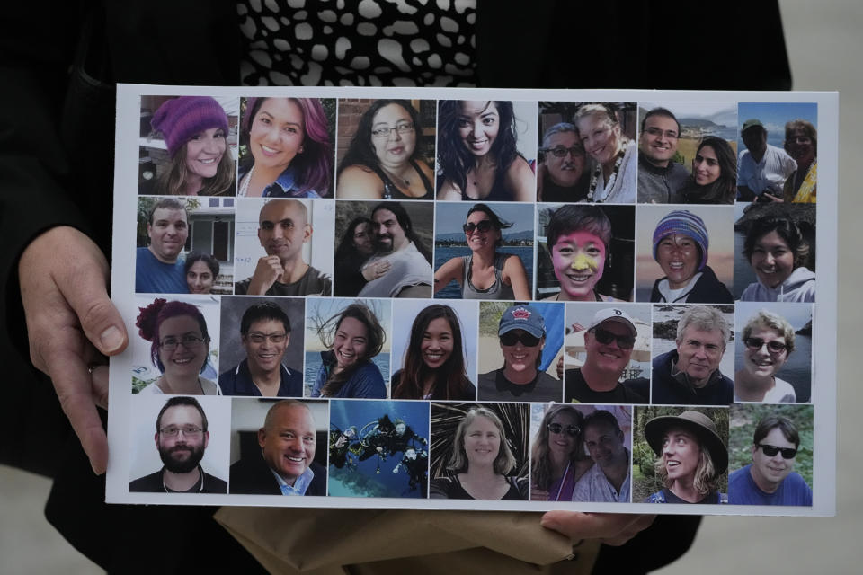 A photo collage of the 34 victims of the Sept. 2, 2019 fire aboard the dive boat, Conception, at Santa Cruz Island, is held by a family member arriving at federal court in Los Angeles, Wednesday, Oct. 25, 2023. The trial against Captain Jerry Boylan was underway Tuesday with jury selection. Boylan has pleaded not guilty to one count of misconduct or neglect of ship officer. (AP Photo/Damian Dovarganes)